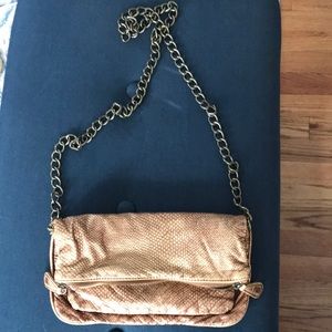 Gold bag with gold chain strap.